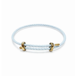 Blue genuine 4mm braided leather bracelet by T.M.J with gold-tone accents and stainless steel details.