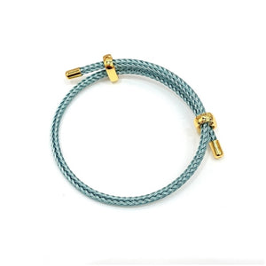 Blue leather bracelet with genuine 4mm braided stainless steel and gold-tone accents by T.M.J, stylish men's accessory.