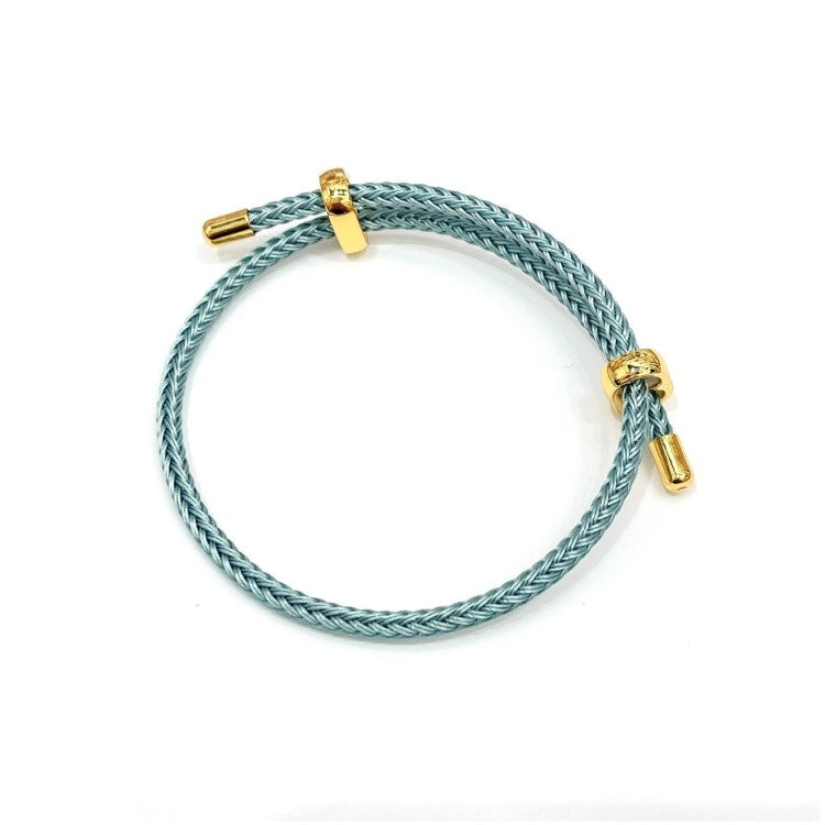 Blue leather bracelet with genuine 4mm braided stainless steel and gold-tone accents by T.M.J, stylish men's accessory.