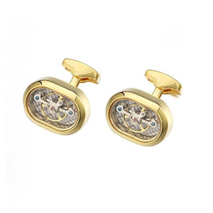Handmade gold-plated watch movement cufflinks by T.M.J, featuring intricate mechanical watch parts on a polished surface.