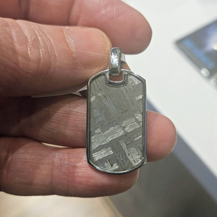 Aletai Meteorite Pendant by T.M.J featuring a stainless steel pendant with a meteorite inlay, hanging on a chain.