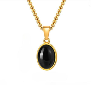 Gold-plated steel pendant with black agate cabochon from T.M.J, featuring a sleek, elegant design and polished finish.