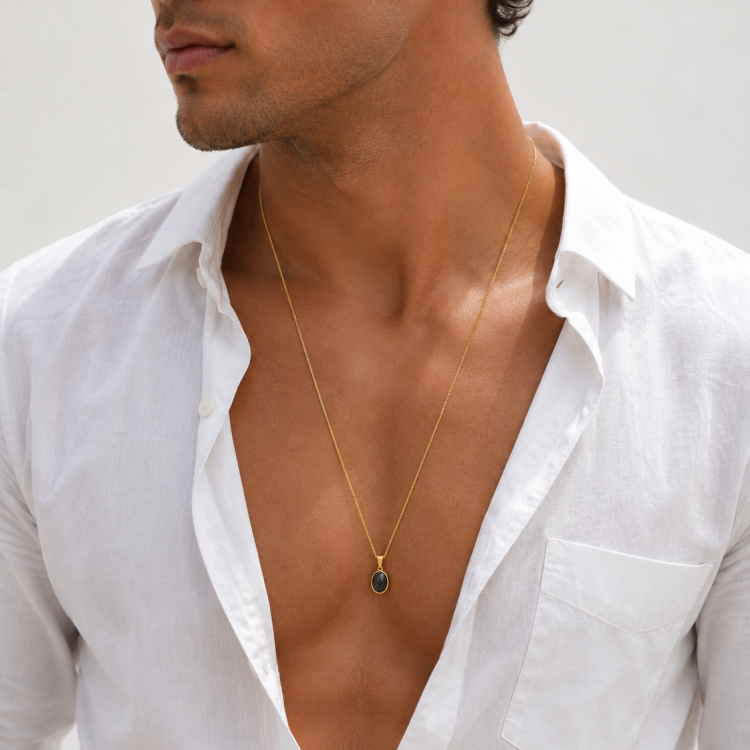 T.M.J gold-plated steel pendant featuring a black agate cabochon, elegant jewelry accessory with a polished design.