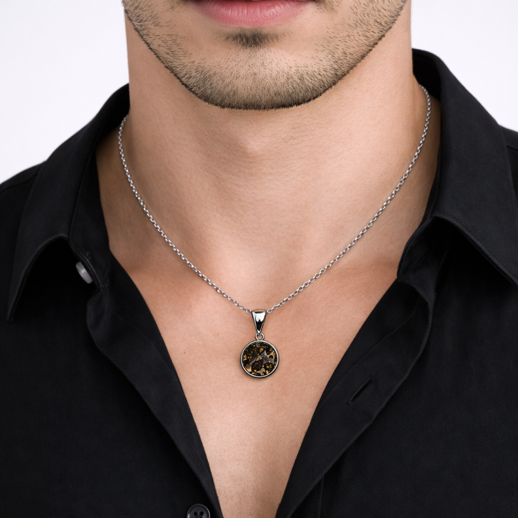 Sterling silver pendant featuring Pallasite meteorite with green olivine crystal inclusions, designed by T.M.J.