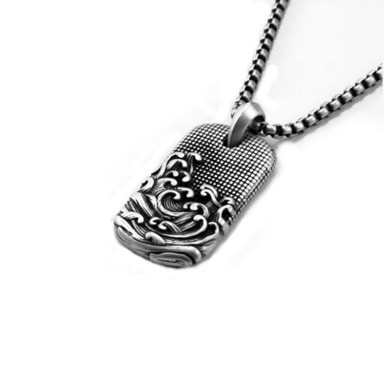 Stainless steel Sea Waves dog tag pendant with chain, featuring a textured ocean wave design, by T.M.J.