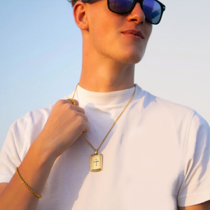 Gold plated stainless steel cross tag pendant from T.M.J, featuring a sleek, polished design for stylish jewelry.