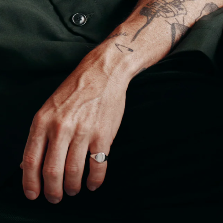 Heritage men's sterling silver oval signet ring, T.M.J brand, showcasing a polished silver ring with engraved oval face.