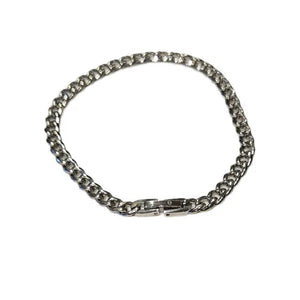 Stainless steel and gold-plated curb link bracelet by T.M.J, 5mm wide, with a polished finish on a white background.