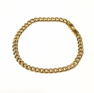 Stainless steel and gold-plated curb link bracelet by T.M.J, 5mm width, 19.5cm length, featuring sleek metallic links.