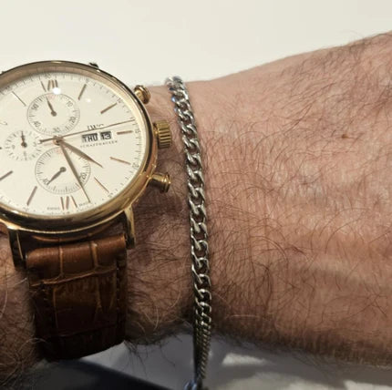 Stainless steel and gold-plated curb link bracelet by T.M.J, 5mm width, 19.5cm length, featuring polished gold accents.
