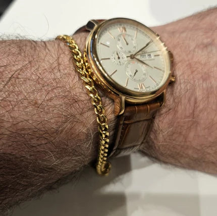 Stainless steel and gold-plated curb link bracelet by T.M.J, 5mm width, 19.5cm length, featuring shiny metallic links.