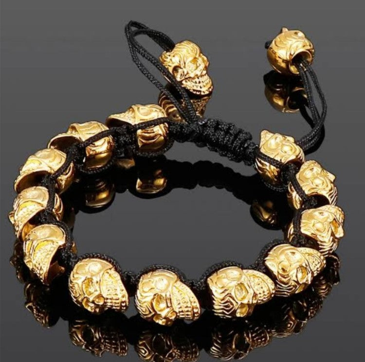 Men’s silver stainless steel skull macrame cuff bracelet with adjustable fit, featuring detailed skull design and intricate knotting.