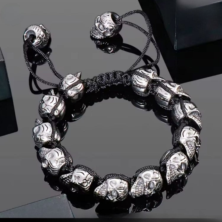 Men’s stainless steel skull macrame cuff bracelet with adjustable fit, featuring a silver finish and intricate design.