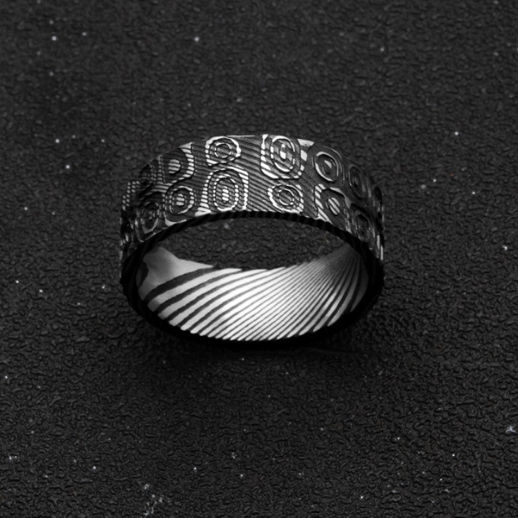 T.M.J men's stainless steel Aegis Damascus ring with ovals and circles, symbolizing cycles, protection, and unity.