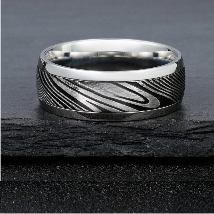 8mm etched Damascus steel and stainless steel ring by T.M.J, showcasing intricate patterns on a sleek silver band.