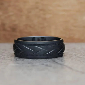 Black zirconium patterned men's stainless steel ring by T.M.J featuring sleek design and intricate detailing.