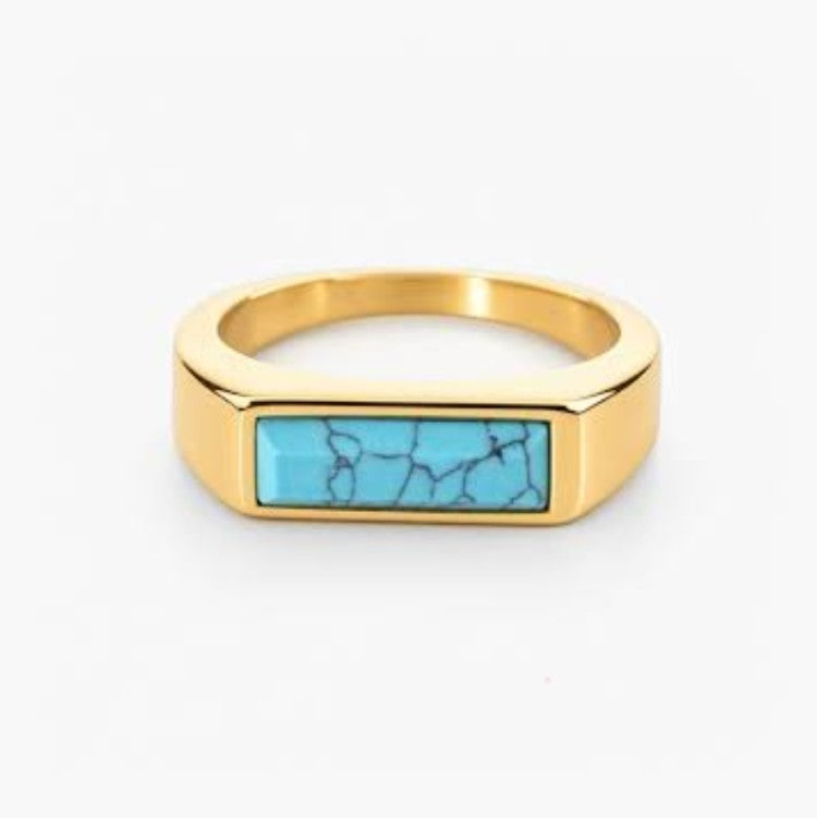 T.M.J stainless steel signet ring with gold plating and turquoise inlay, featuring a sleek, polished design and detailed craftsmanship.