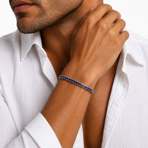 Sterling silver princess cut sapphire blue CZ tennis bracelet with 3mm stones, featuring a delicate chain design.