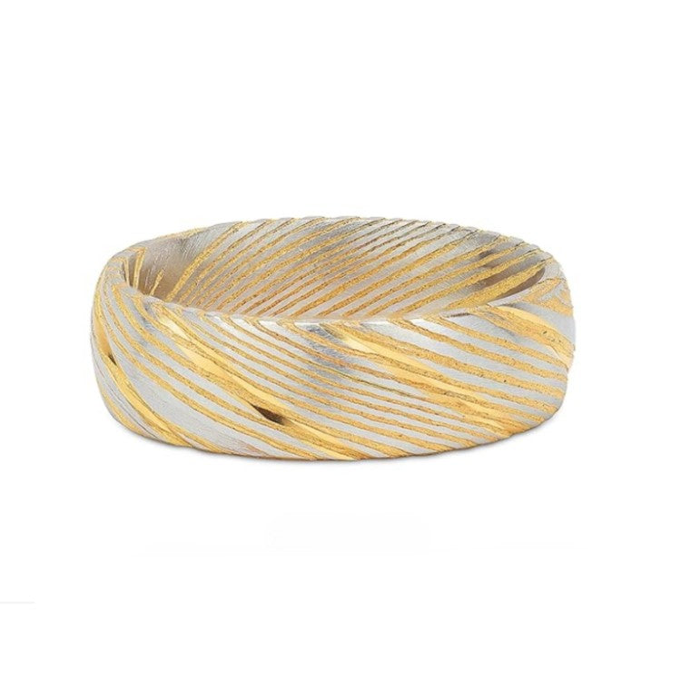 Polished gold Cerakote Damascus stainless steel ring by T.M.J, showing the Damascus steel interior and detailed craftsmanship.
