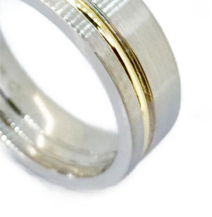 Titanium satin finish ring with gold inlay, 7mm wide, from T.M.J, showcasing sleek design and contrasting metallic accents.