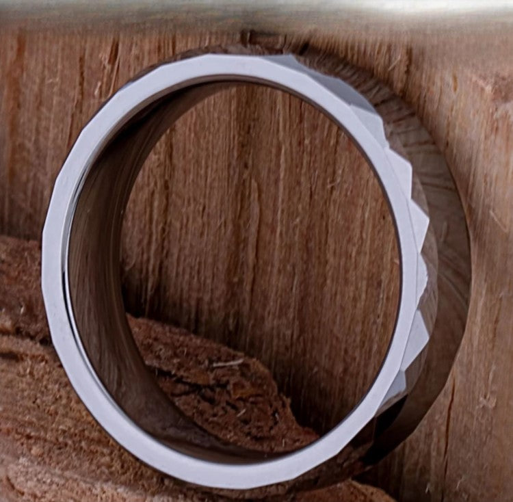 Silver tungsten carbide ring called The Rumba by T.M.J, featuring a sleek, polished design with subtle branding details.