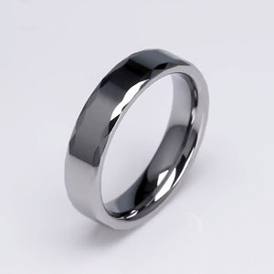 Silver tungsten carbide ring called The Rumba by T.M.J, featuring a sleek, polished band with subtle engraving details.