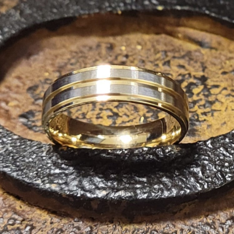 T.M.J tungsten carbide ring with yellow gold satin finish top and polished gold edges, showcasing a sleek and elegant design.