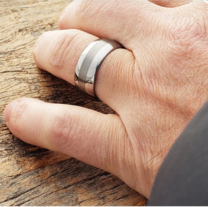 Silver tungsten carbide ring called "The Celestial" by T.M.J, featuring a sleek, polished design with celestial-inspired details.