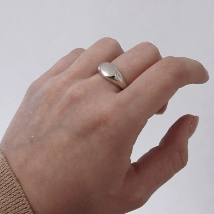 Silver stainless steel classic oval signet pinky ring with smooth finish, designed for elegant and stylish wear.