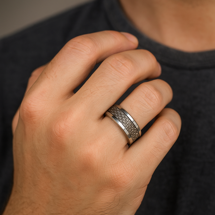 Sleek silver braided stainless steel ring with carbon fiber inlay, designed by TMJ, showcasing a modern and stylish jewelry piece.