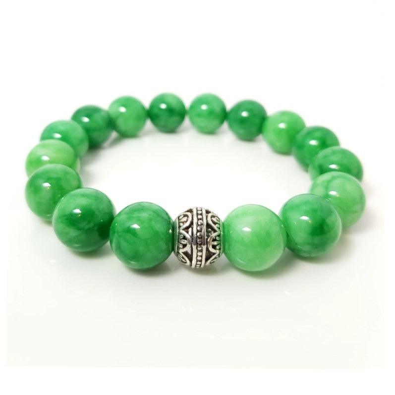 Green Jadeite beaded bracelet with 12mm beads from T.M.J, featuring a stretchy design and natural green gemstone appearance.