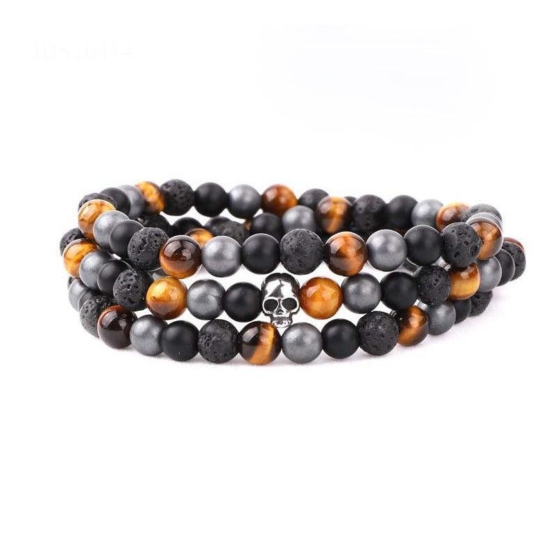 Multi-beaded silver skull wrap-around bracelet by T.M.J, featuring intricate beadwork and a stylish skull design.