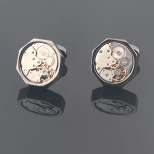 T.M.J mechanical cufflinks featuring tourbillon watch gear design with intricate gear detail and polished metal finish.