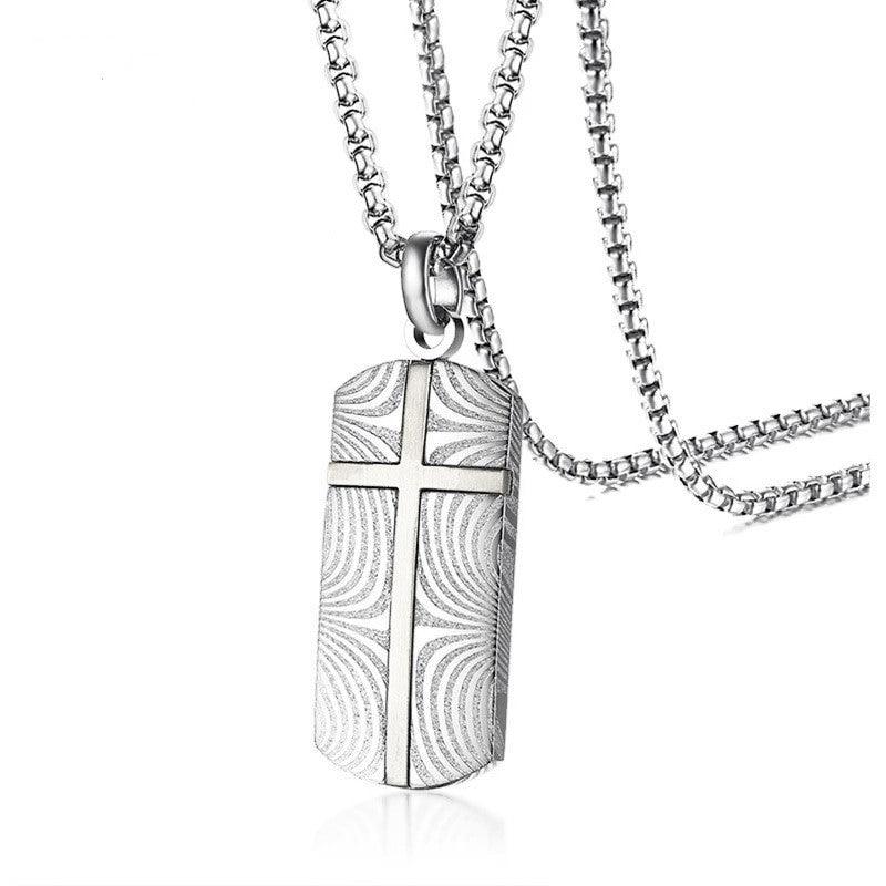 Men's Damascus stainless steel cross dog tag pendant with detailed design, crafted by T.M.J, on a chain.