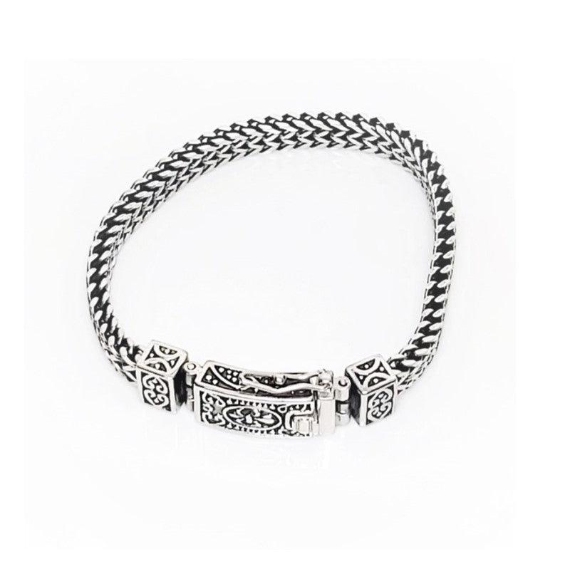 Stainless steel heavy link bracelet with box lock, T.M.J brand, showcasing durable, polished metal links and secure clasp.