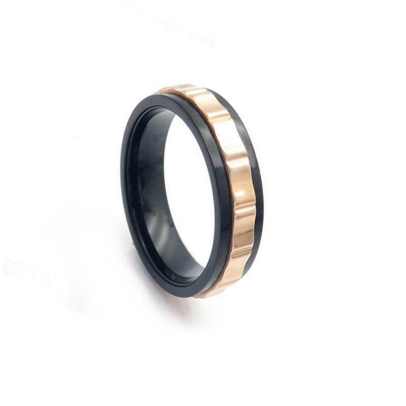 Stainless steel spinner ring with black IP finish and gold accents, by T.M.J, featuring a sleek and modern design.