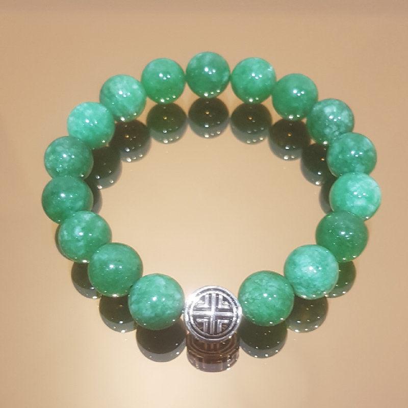Natural Green Jadeite Jade with Tibetan Silver Bead BraceletThe Bracelet is made of one 8 x12 mm Tibetan silver bead, classically designed men’s bracelet works well with any outfit. 
Subtle earth color Natural Green Jadeite JBead BraceletsT.M.JTheodore Men's JewelryNatural Green Jadeite Jade