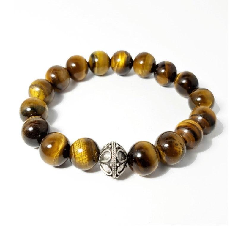 Tiger Eye and Silver Bead BraceletThis 12mm Tiger Eye elasticated bead bracelet with a 14X8mm 925 silver bead. This a true piece of art you'll be proud to own and happy to wear for any occasion. As aBead BraceletsT.M.JTheodore Men's JewelryTiger Eye and Silver Bead Bracelet